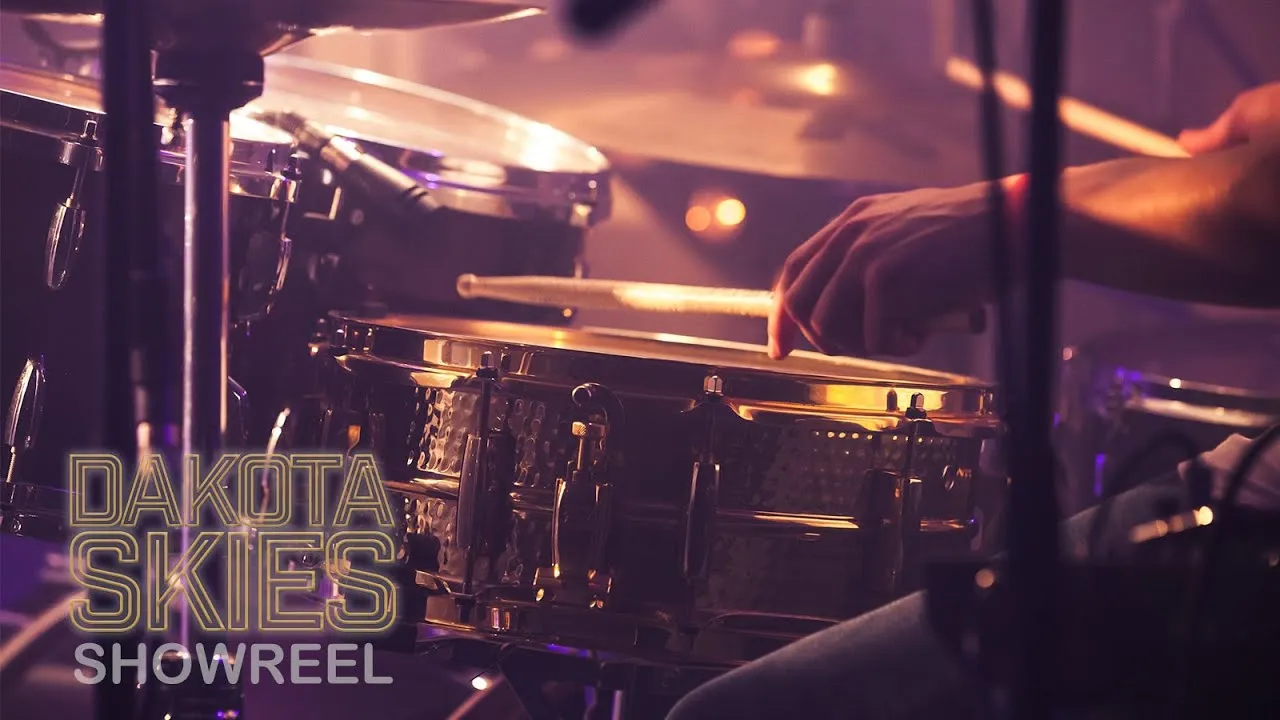 Close-up of a drummer playing a drum kit with text overlay reading 'Dakota Skies Showreel'.